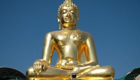 Golden Buddhist Statue shining under the sunlight, Thailand